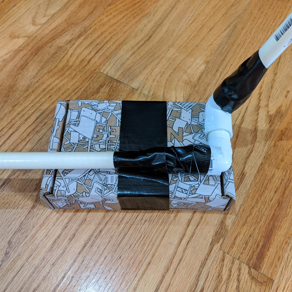Connect an elbow piece to the end of the PVC pipe and tape them securely. 