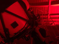 A person observing through a telescope in July 2021 at the 'Scopes at the Adler small-group experience inside the Adler Planetarium's Doane Observatory.