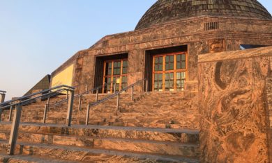 This is an image showing the outside of the Adler Planetarium in Chicago, IL at sunset in the fall.