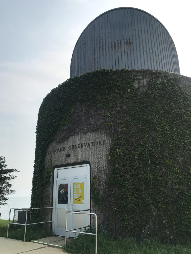 "The Doane Observatory" at the Adler Planetarium with green ivy growing all around the circular building.