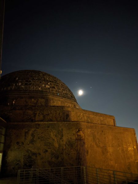 The Adler Planetarium with the Moon, Jupiter and Saturn in the background.