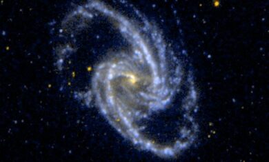 A spiral galaxy with a yellow dot in the center and blue and white dots spiraling out from the center