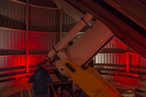 An image of an Adler guest, telescope observing in the Doane Observatory.