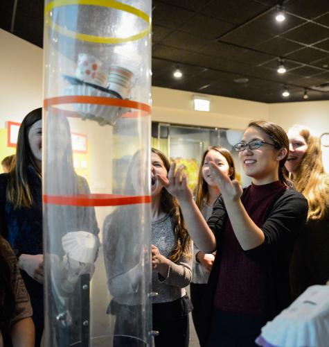 An image of Adler guests eagerly participating in a science experiment in the Adler's "Community Design Lab."